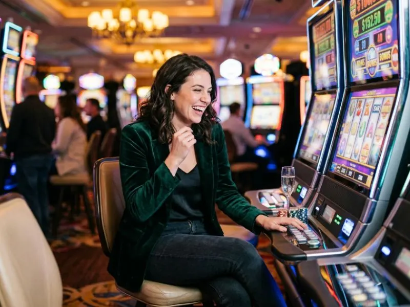 Woman watching slot reels with excitement at PH365 online casino
